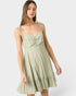 Woman wearing a light green dress on a white background