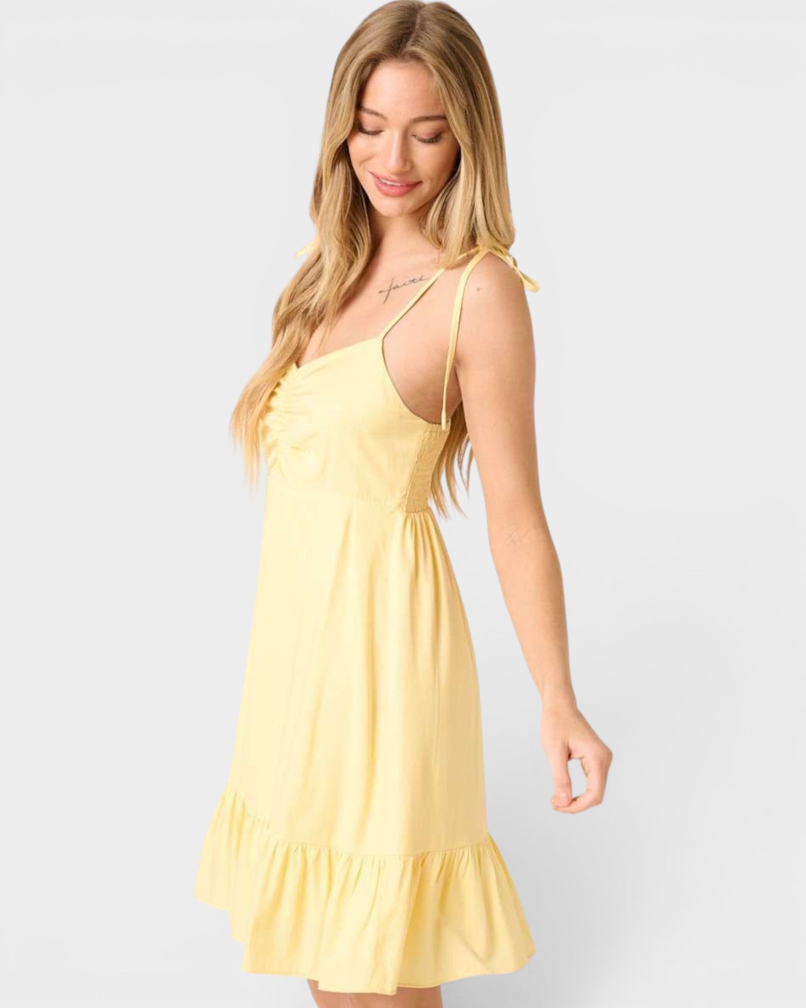 Woman wearing a yellow dress on a white background