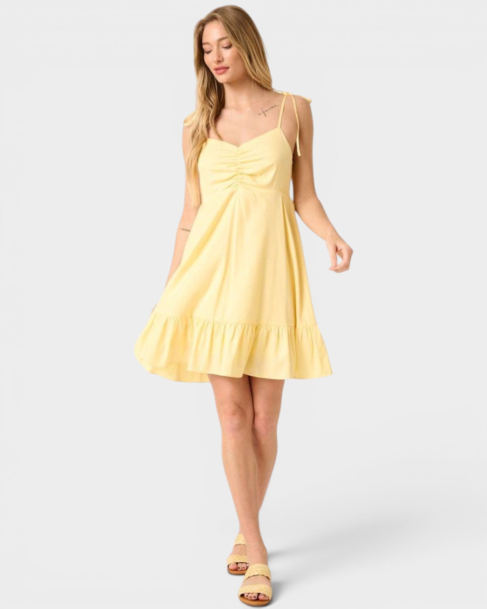 Woman wearing a yellow dress on a white background