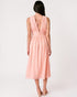 Woman wearing a pink dress with a white background