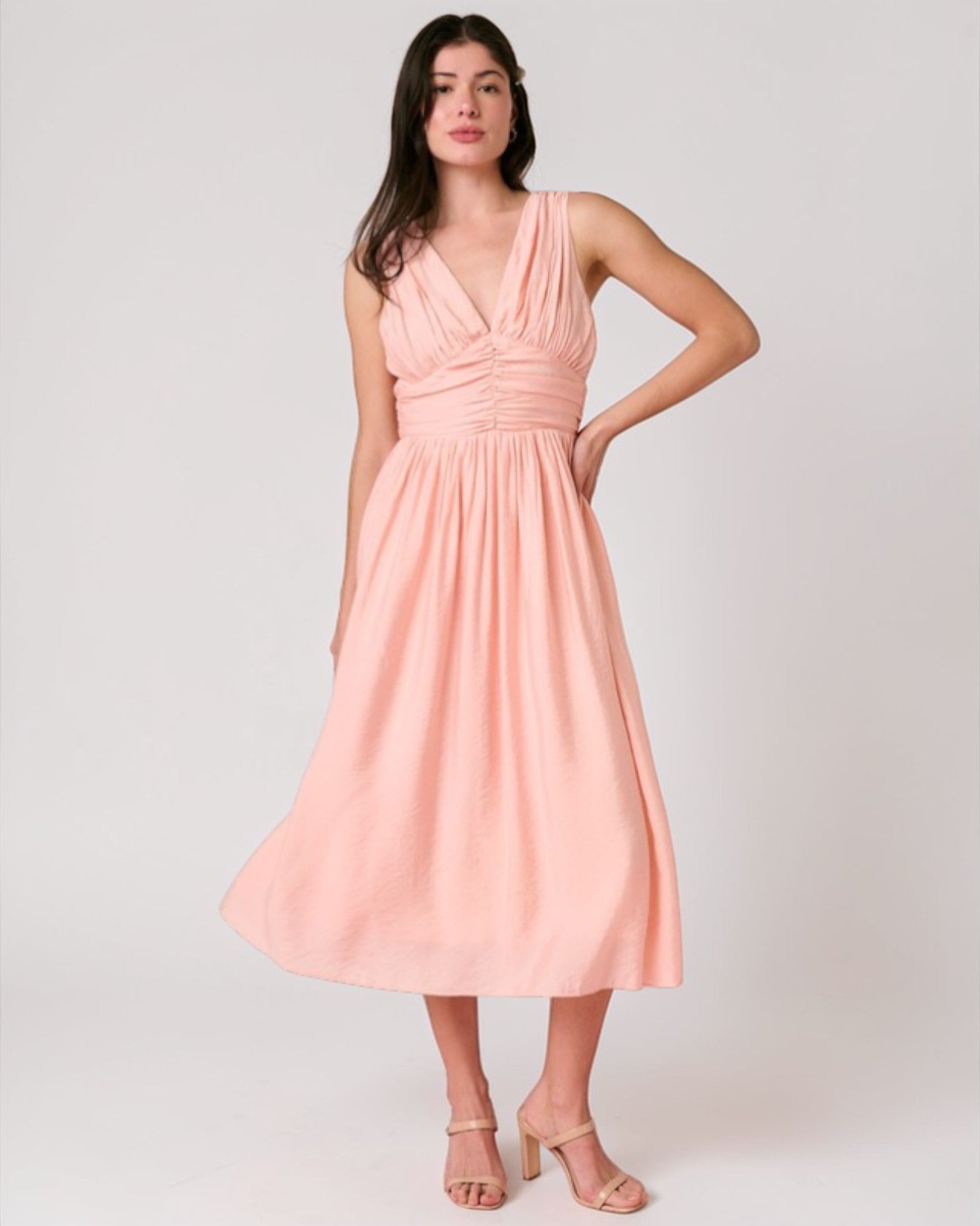 Woman wearing a pink dress on a white background