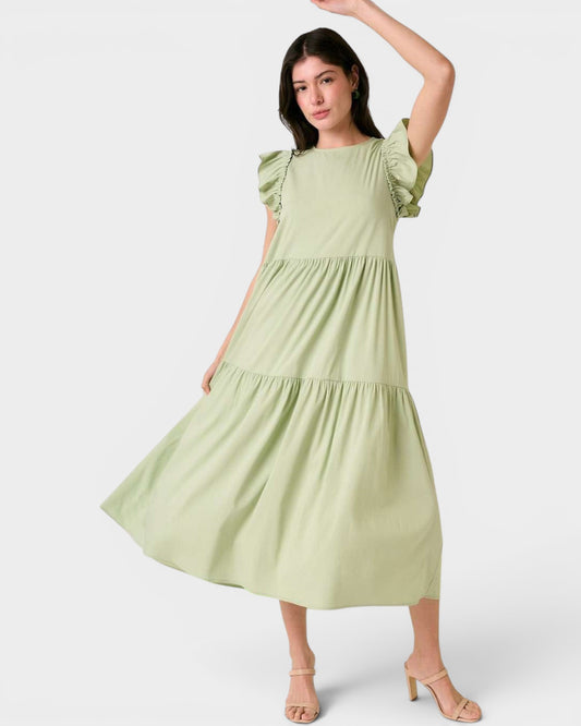 Woman wearing a light green dress on a white background