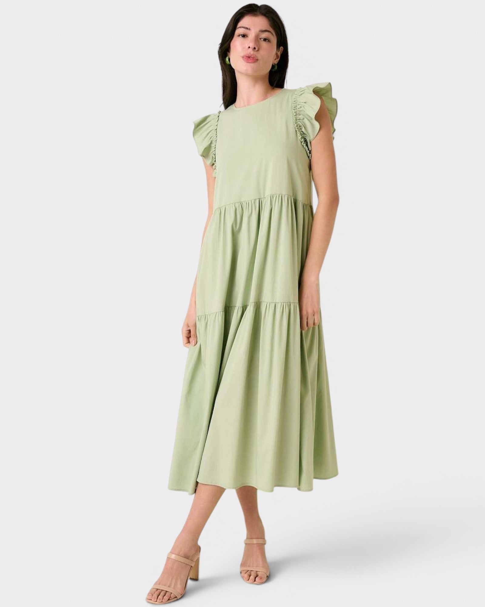 Woman wearing a light green dress on a white background