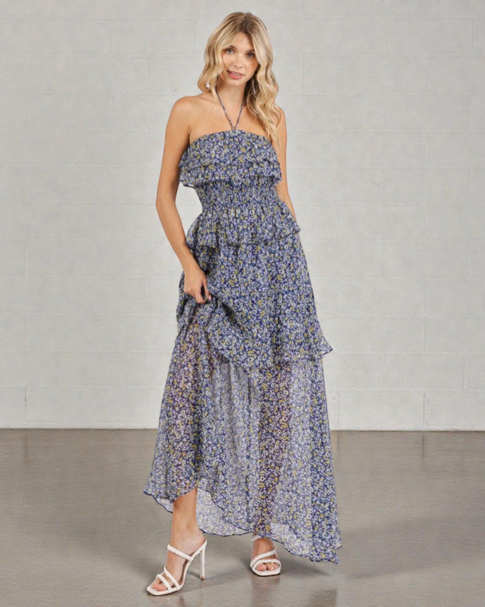 Woman wearing a floral dress against a plain background