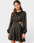 Woman wearing a black dress with long sleeves on a white background
