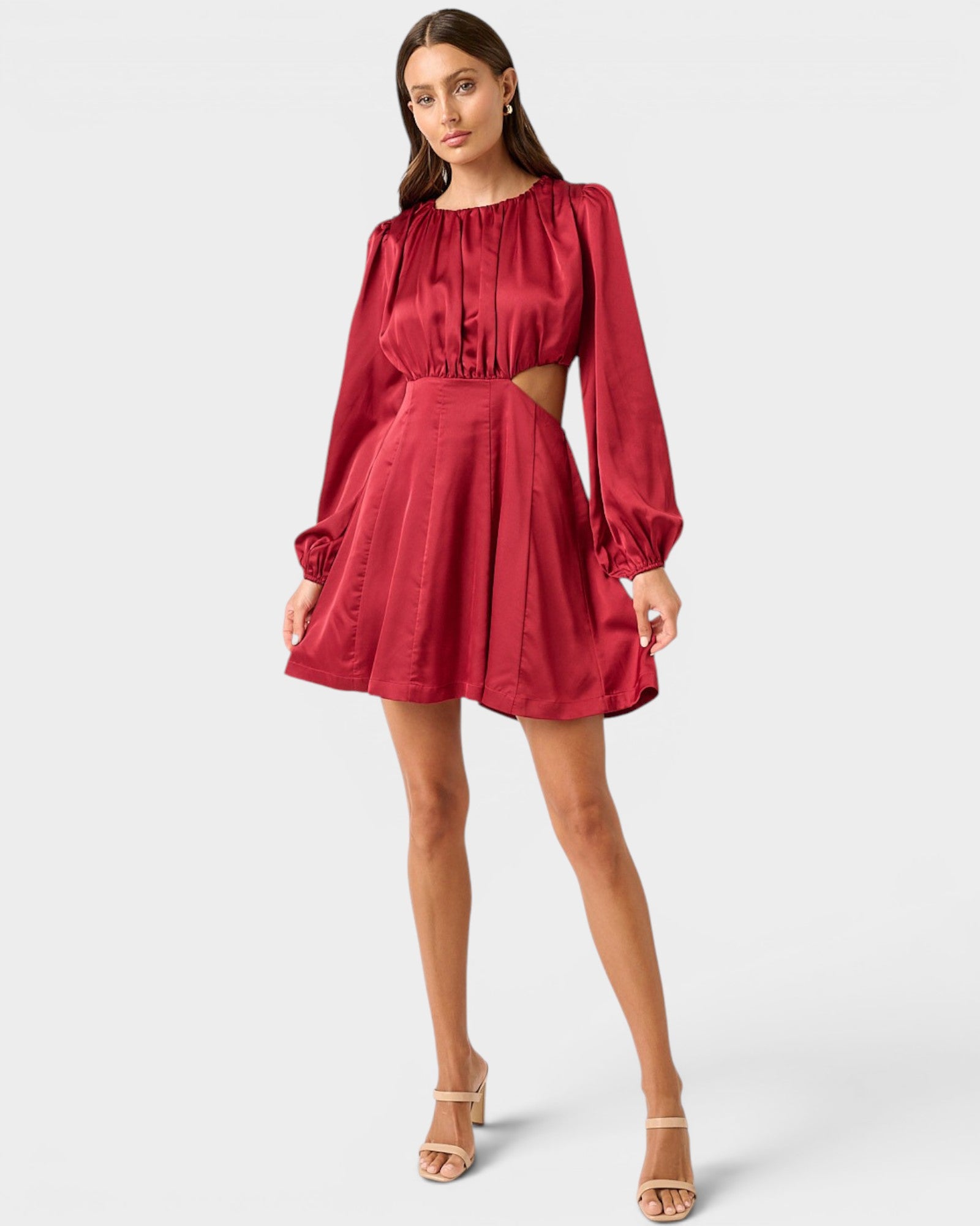 Red dress with long sleeves and cutout design on a white background