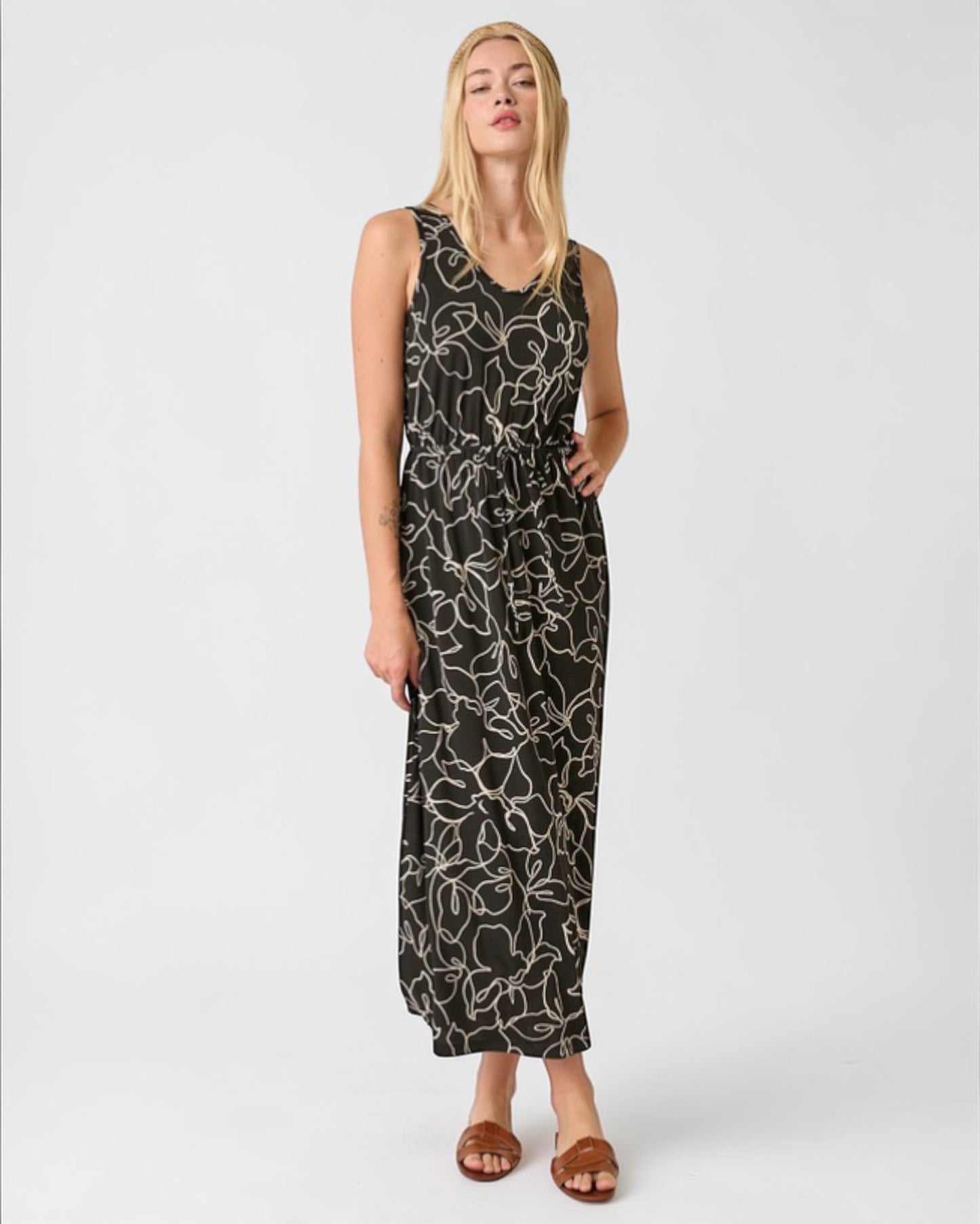 Woman wearing a black patterned dress on a white background