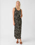 Woman wearing a black patterned dress on a white background