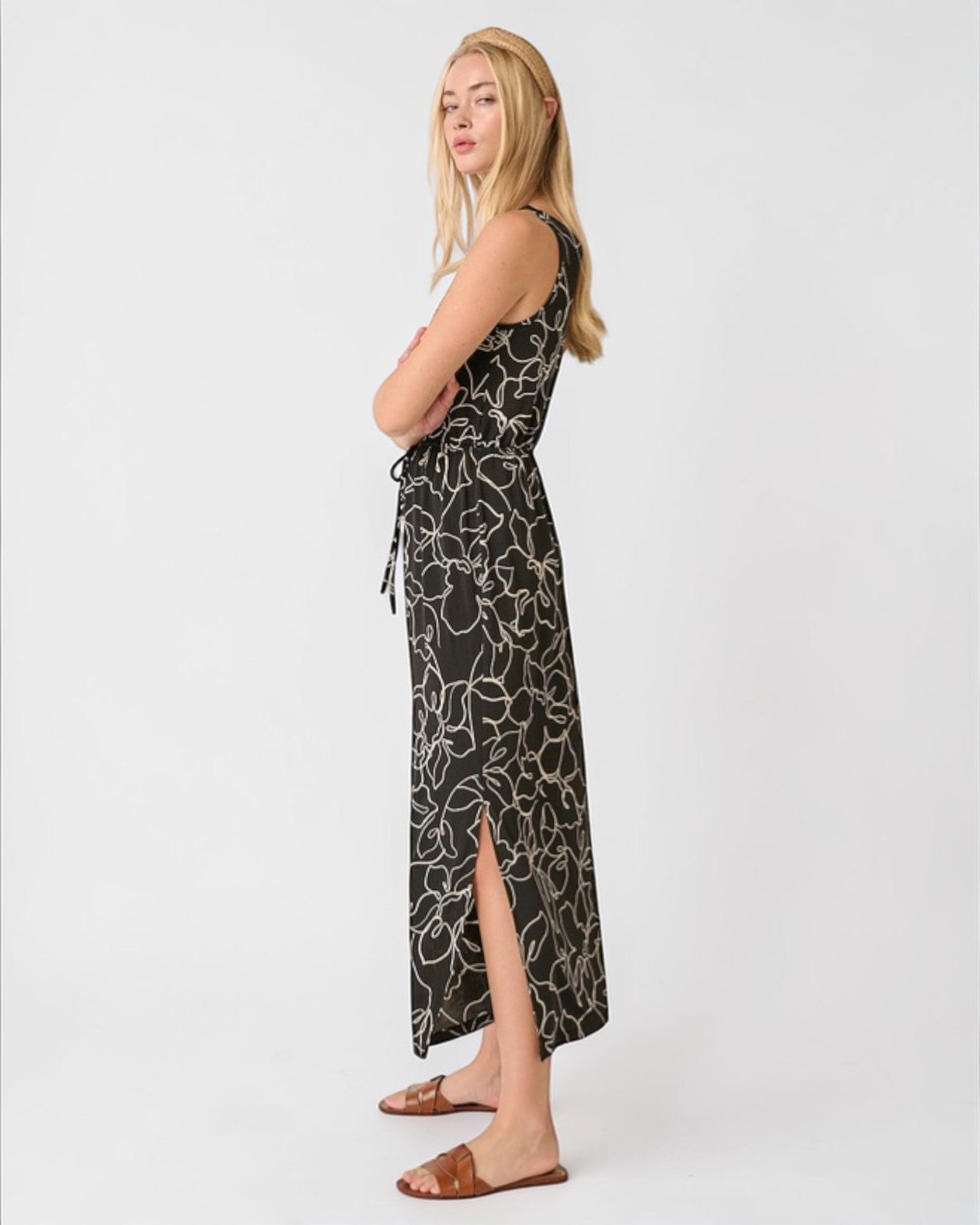 Woman wearing a black floral dress on a white background
