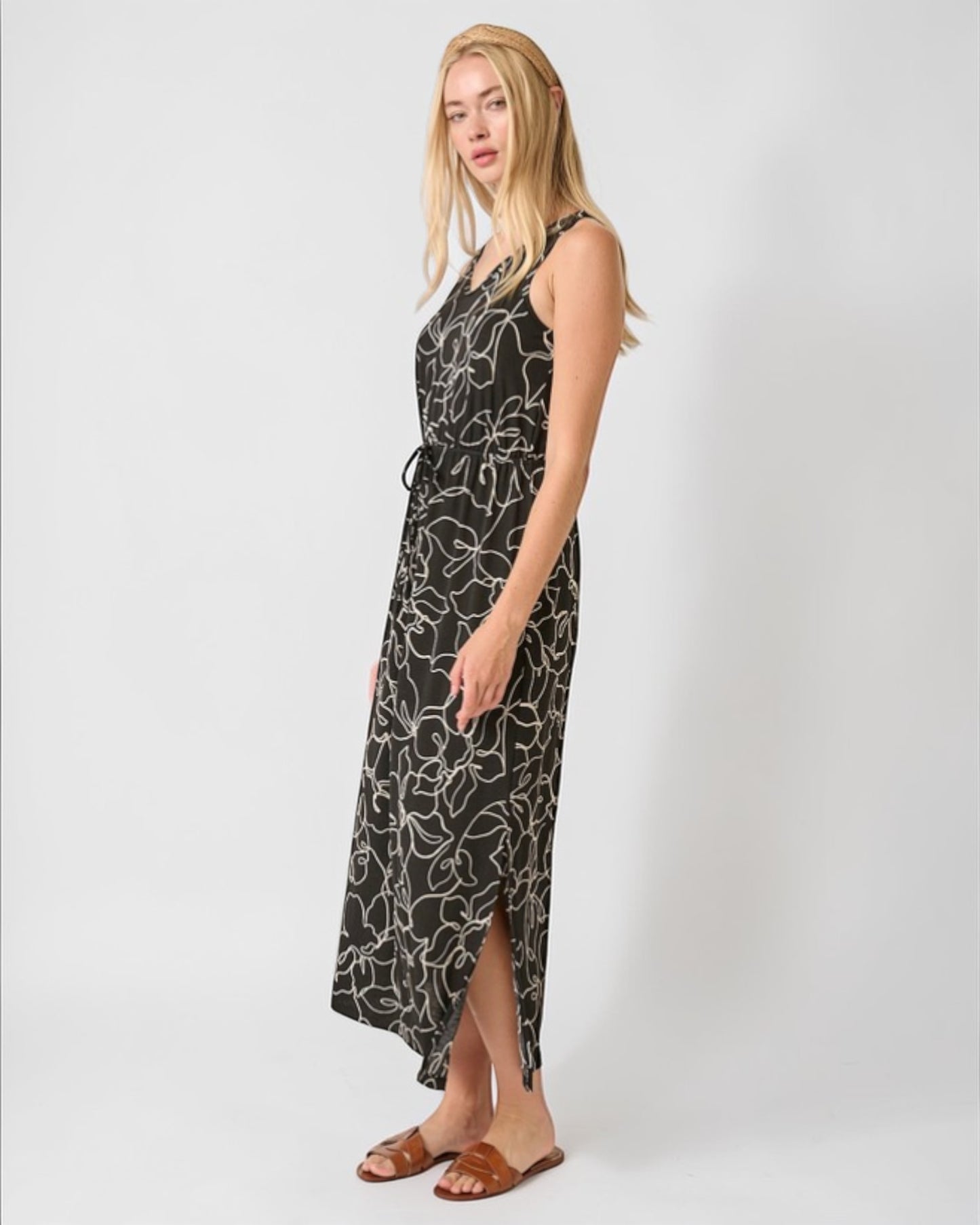 Woman wearing a black floral dress on a white background