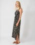 Woman wearing a black floral dress on a white background
