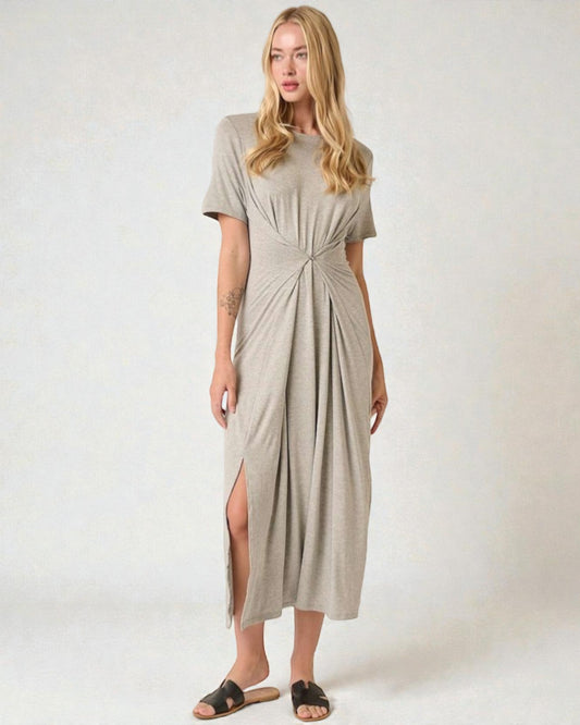 Woman wearing a beige dress with a knot detail on a white background