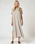 Woman wearing a beige dress on a white background