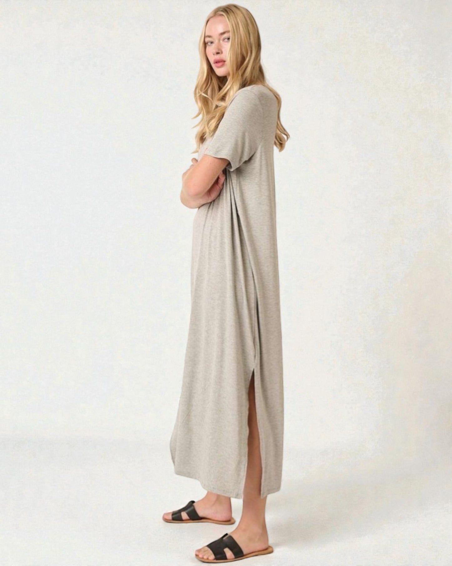 Woman wearing a long beige dress on a white background