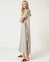 Woman wearing a long beige dress on a white background