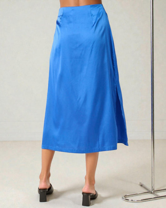 Blue skirt worn by a person on a plain background