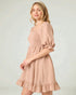 Woman wearing a pink dress against a light background