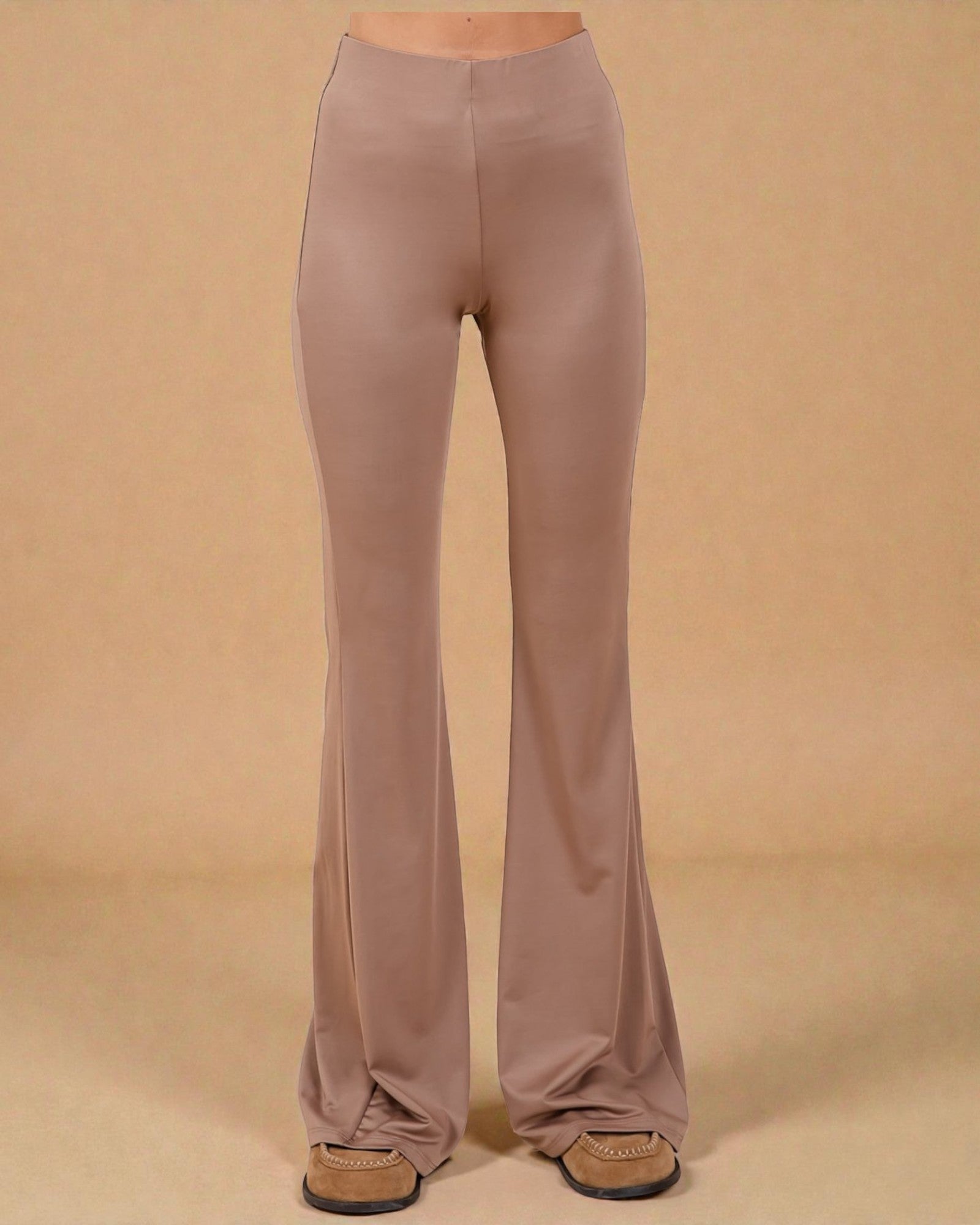 Mauve bell-bottom pants on a beige background