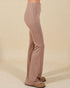Brown pants worn by a person on a beige background