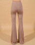 Pair of beige flared pants on a beige background
