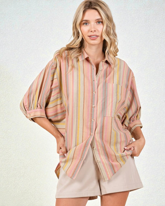 Woman wearing a striped shirt and shorts on a white background