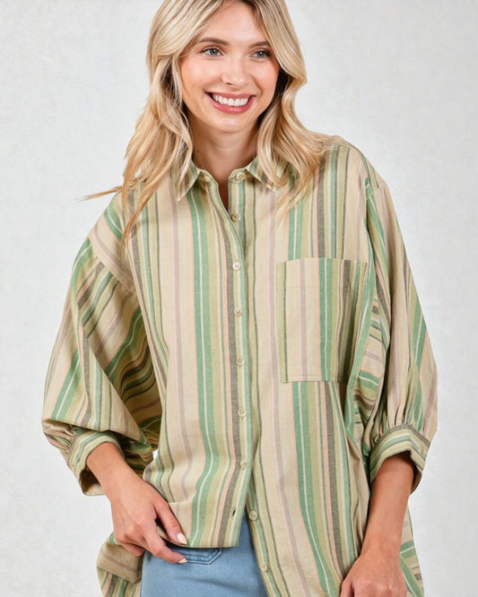 Woman wearing a striped shirt with a neutral background