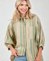 Woman wearing a striped shirt with a neutral background
