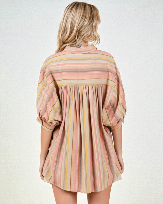 Woman wearing a striped dress with long sleeves on a white background