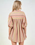 Woman wearing a striped dress with long sleeves on a white background
