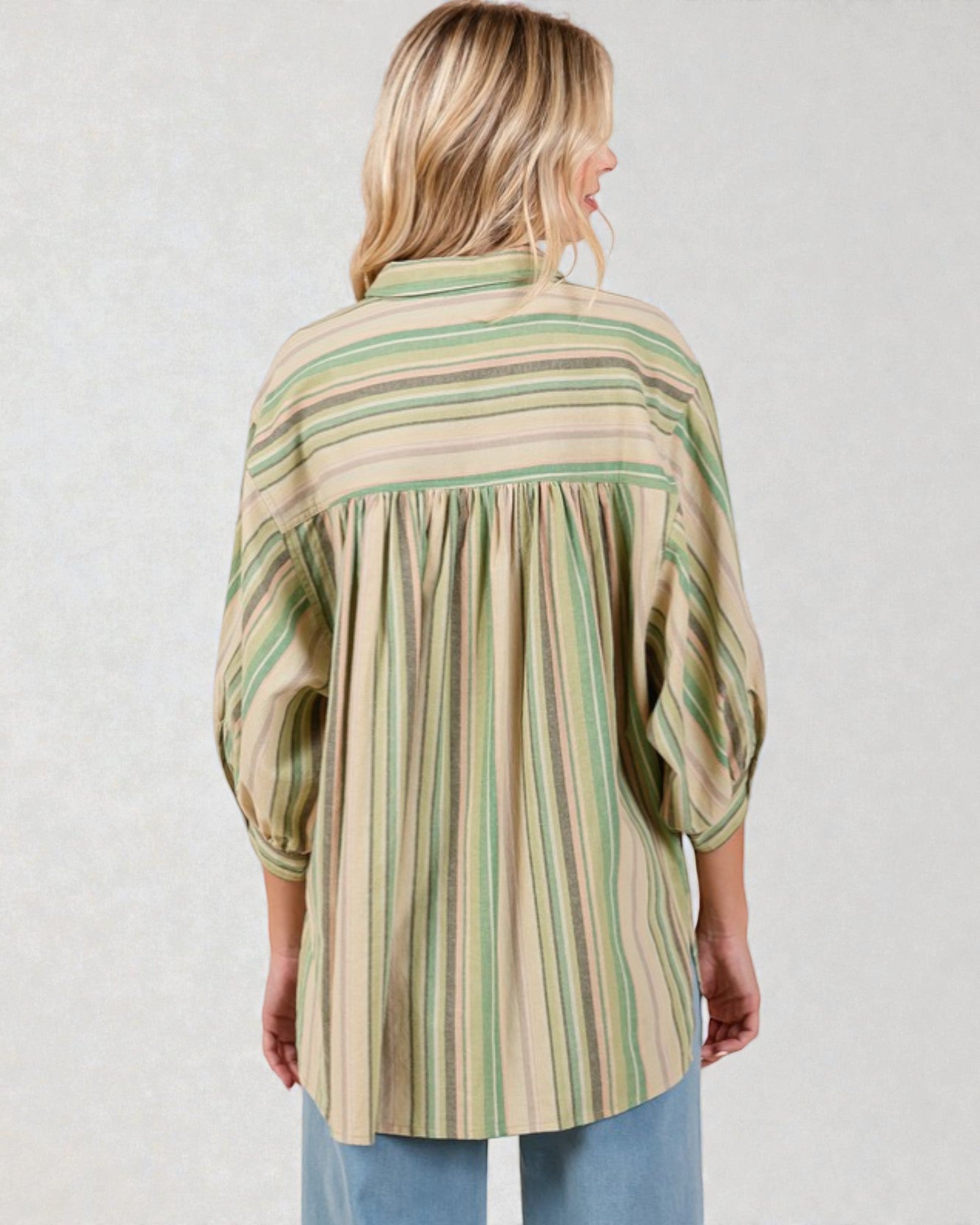 Woman wearing a striped shirt with a plain background