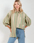 Woman wearing a striped shirt and jeans against a white background