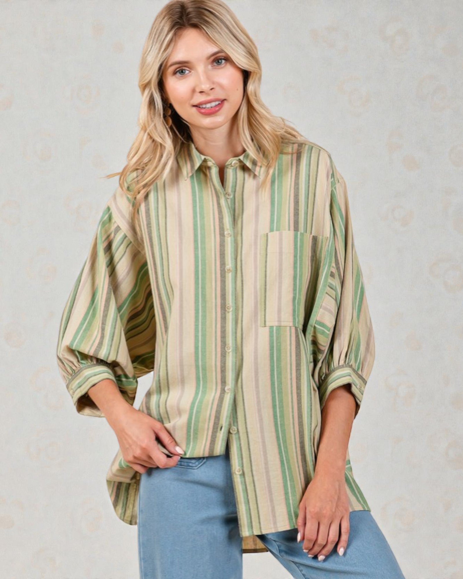Woman wearing a striped shirt with a neutral background