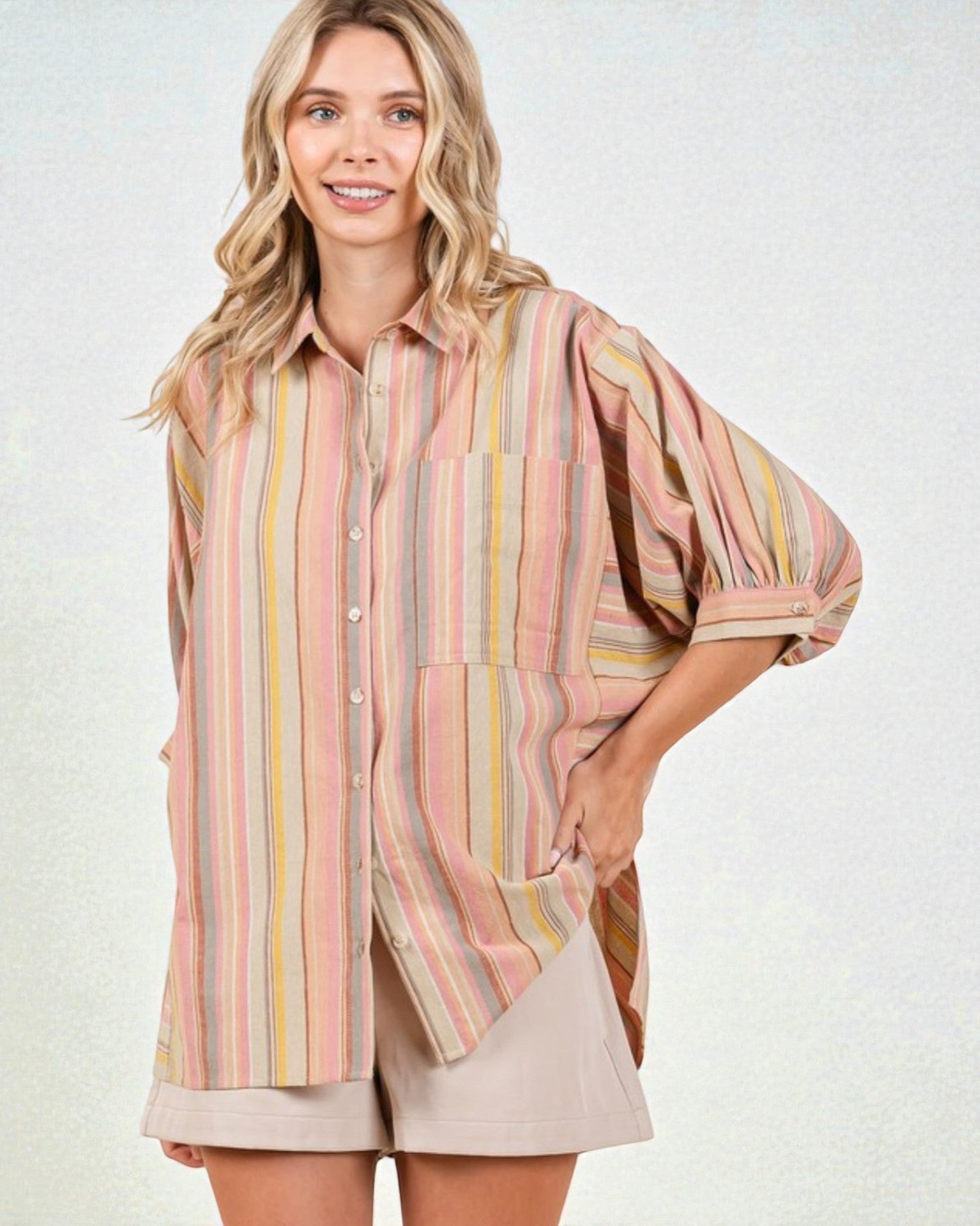Woman wearing a striped shirt and shorts on a white background