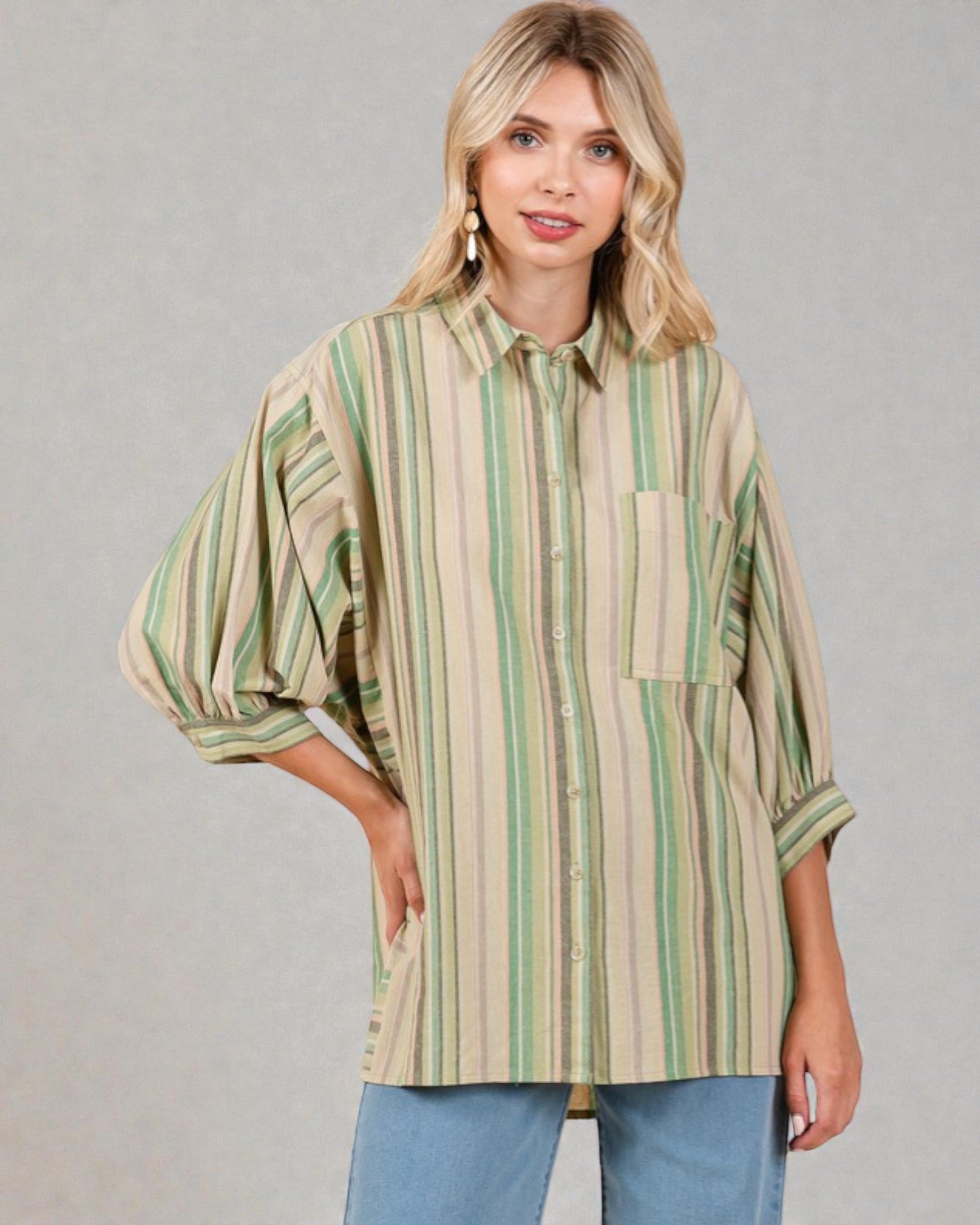 Woman wearing a striped shirt with a neutral background