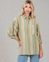 Woman wearing a striped shirt with a neutral background