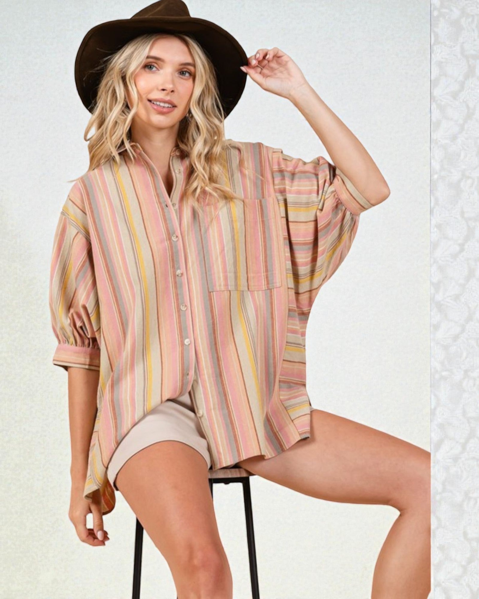 Woman wearing a striped shirt and hat on a white background