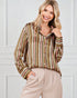Woman wearing a striped shirt and beige pants against a white background
