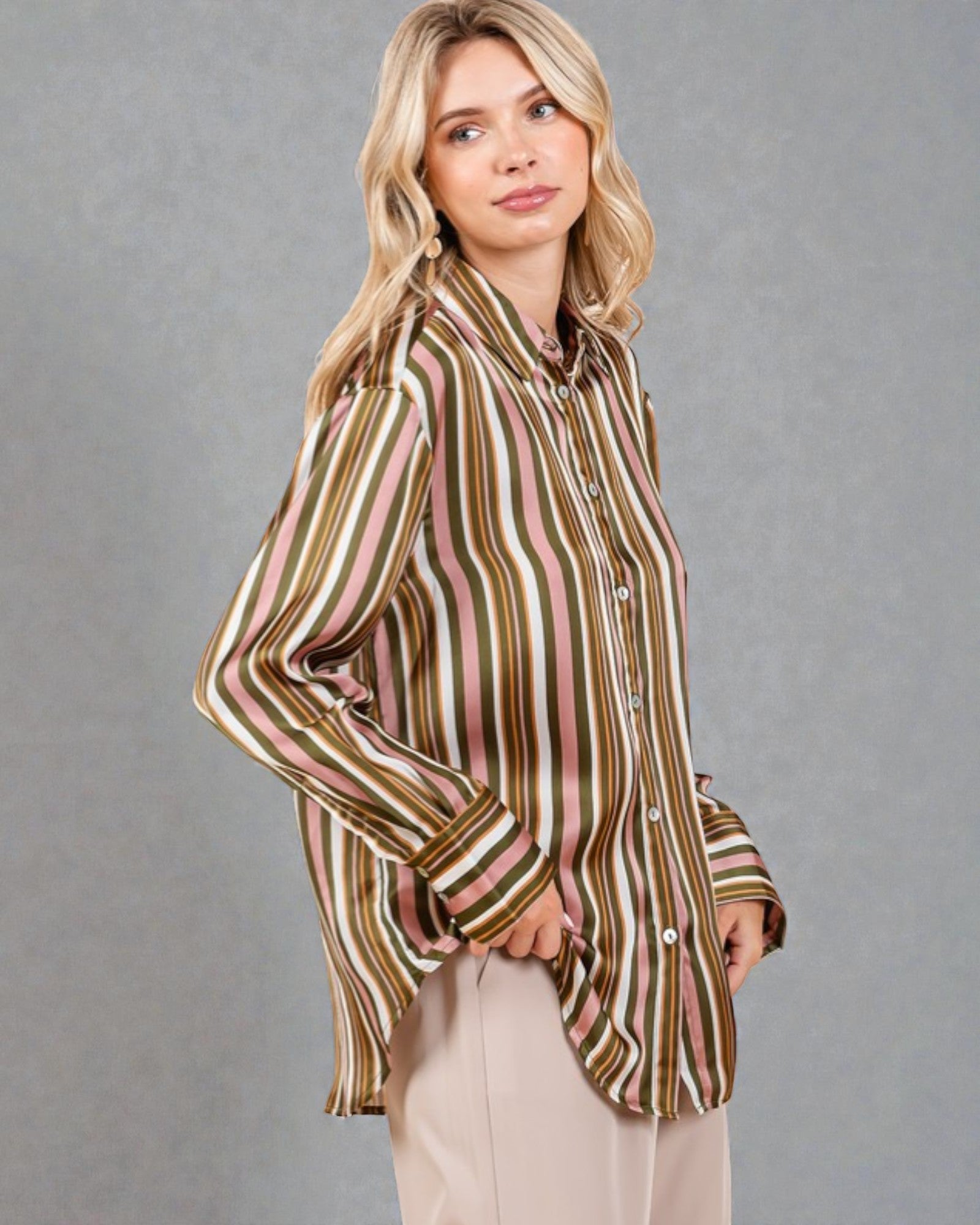 Woman wearing a striped shirt against a gray background