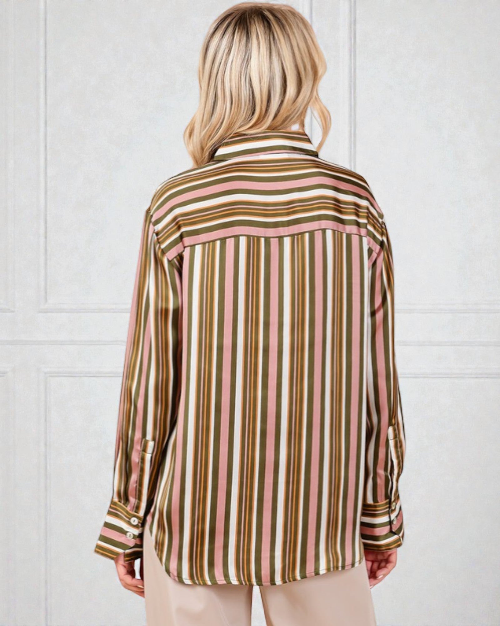 Person wearing a striped shirt with a white background