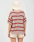 Person wearing a striped shirt and hat on a plain background