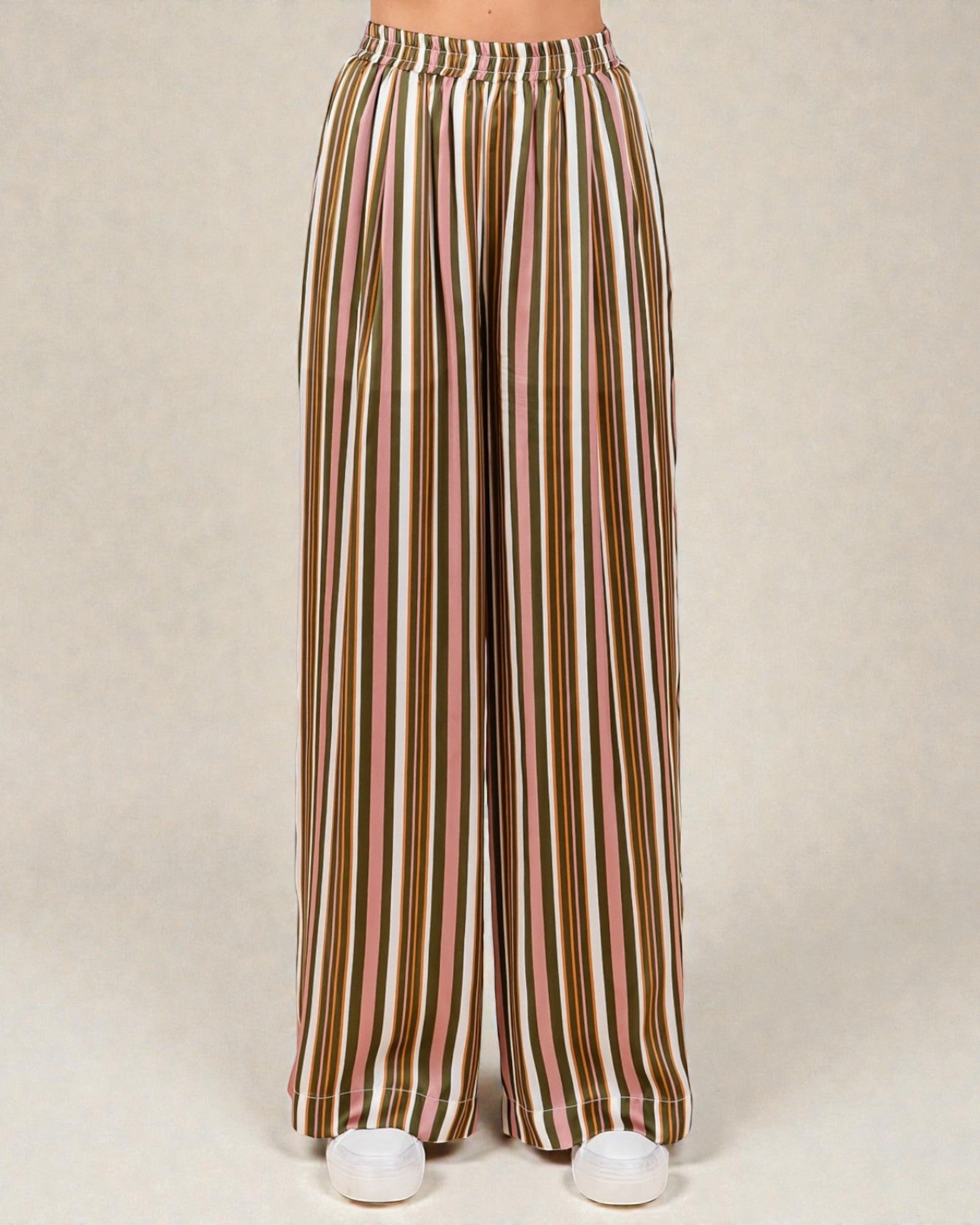 Striped wide-leg pants on a beige background