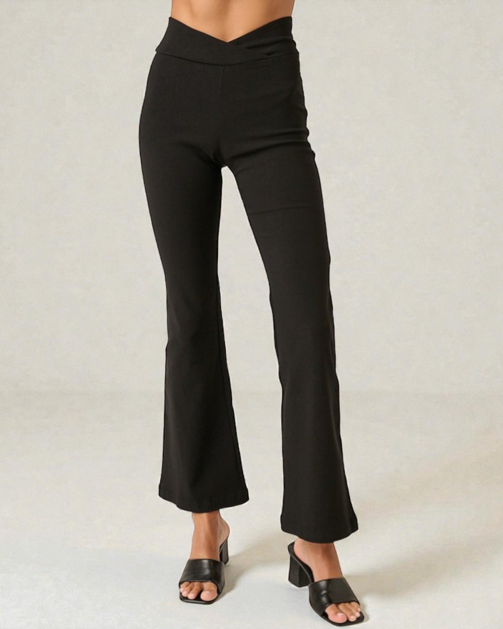Black pants worn by a person on a white background