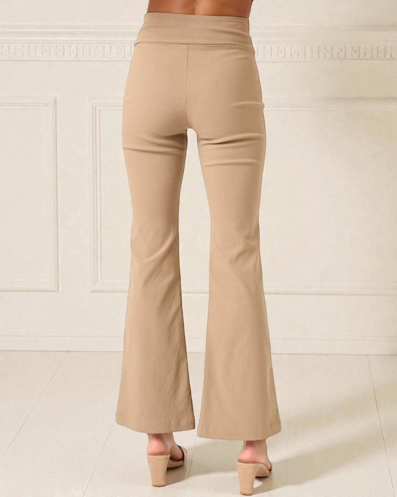 Beige flared pants worn by a person on a light background