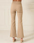 Beige flared pants worn by a person on a light background