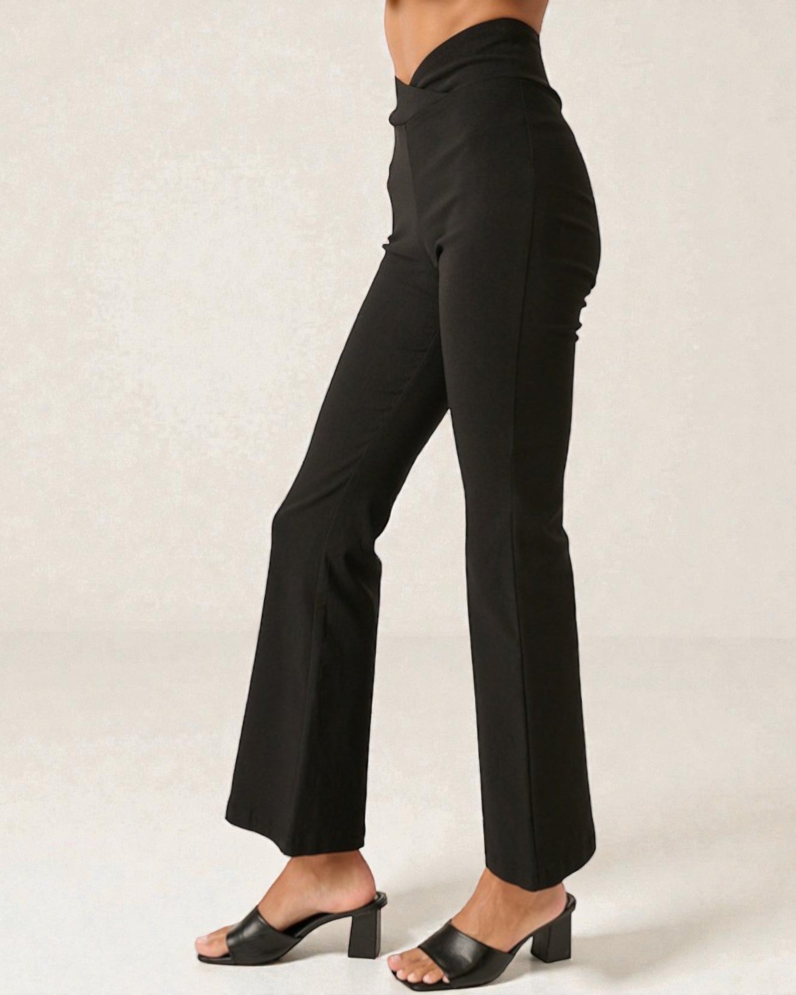 Black high-waisted pants worn by a person on a plain background