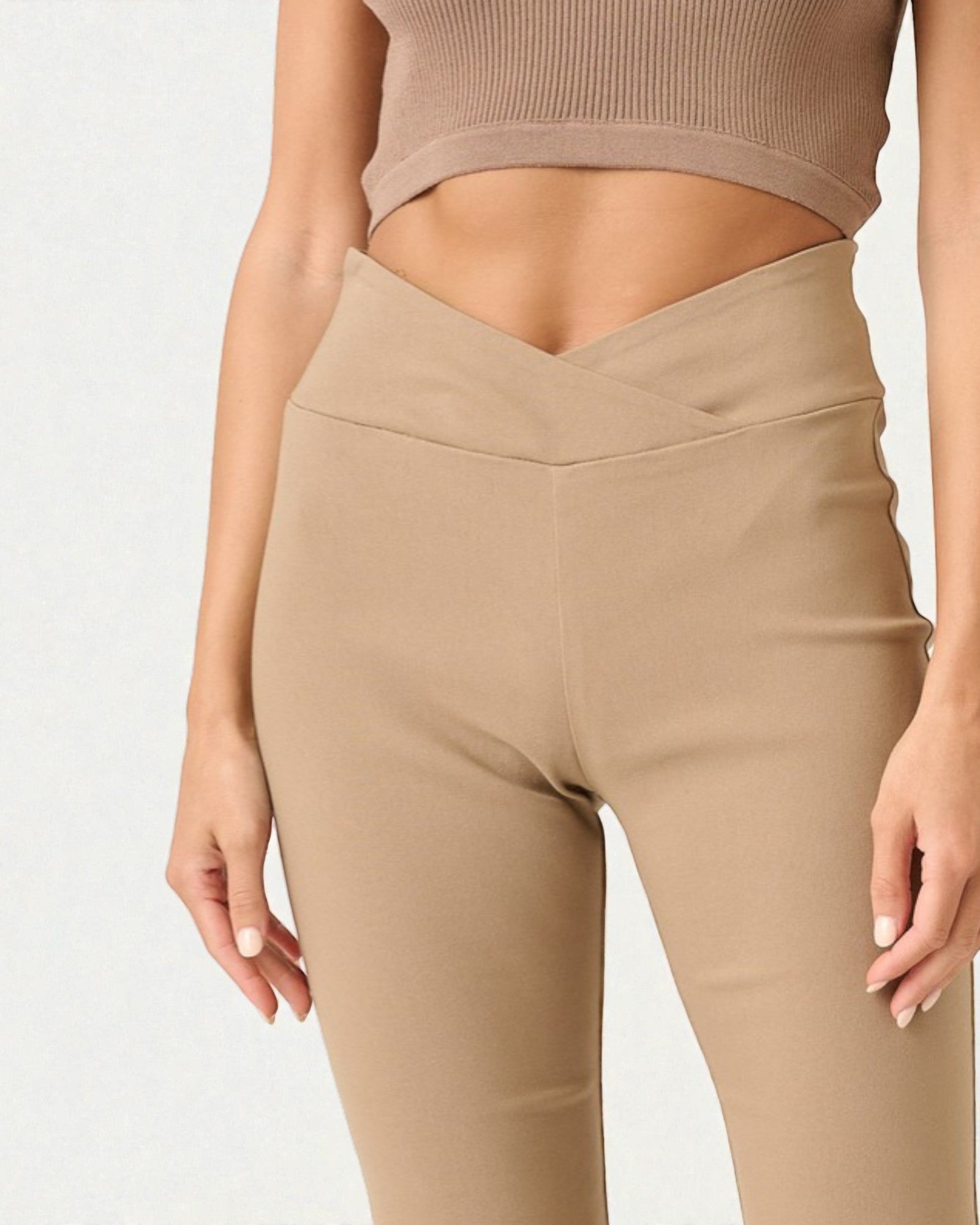 Beige leggings worn by a person on a light gray background