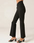 Black high-waisted pants worn by a person on a plain background