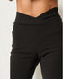 Black high-waisted pants on a plain background