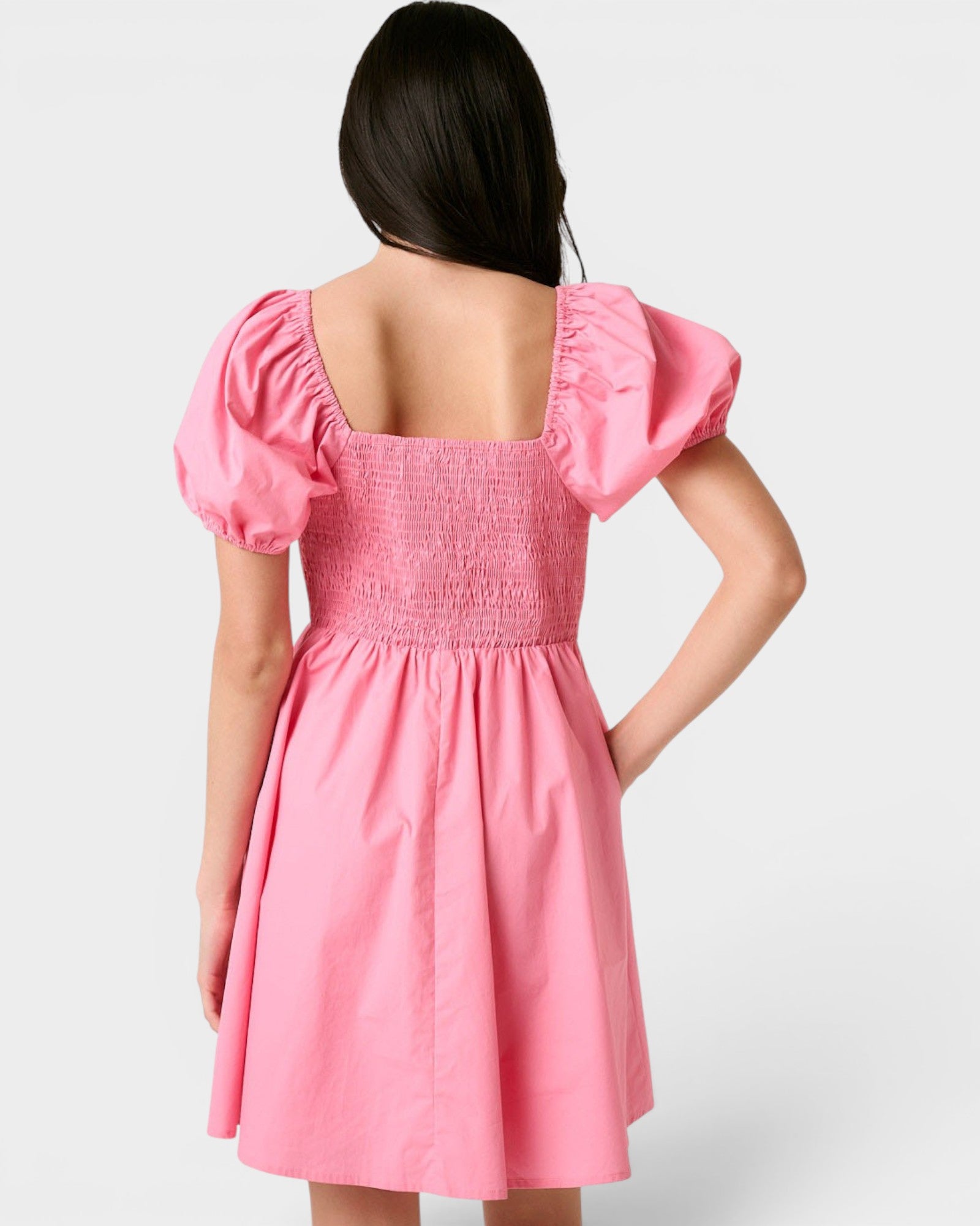 Pink dress with puff sleeves on a white background