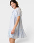 Woman wearing a light blue dress on a white background